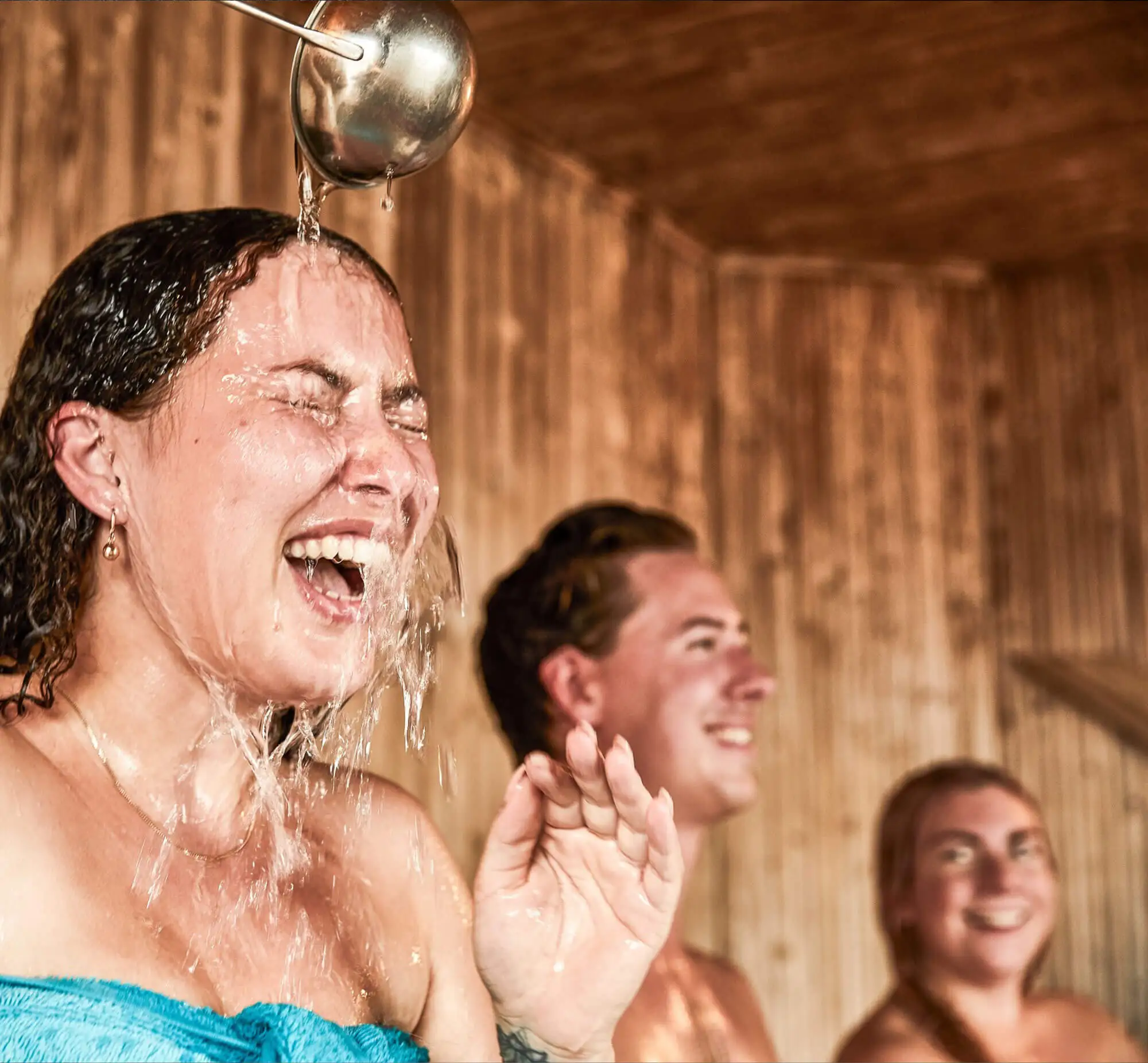 People relaxing inside a wooden sauna