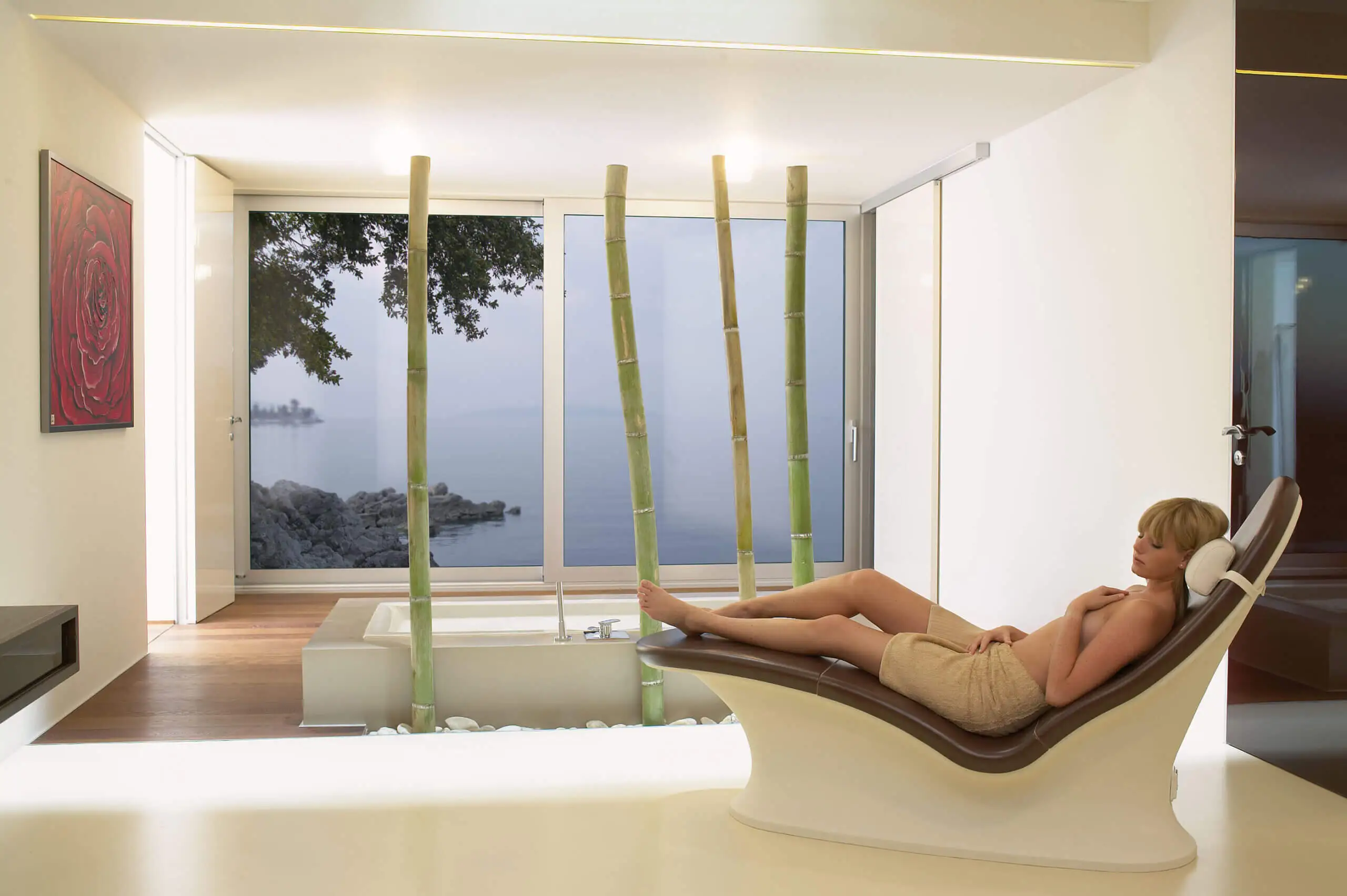 Woman sitting on a concrete bench in a modern spa